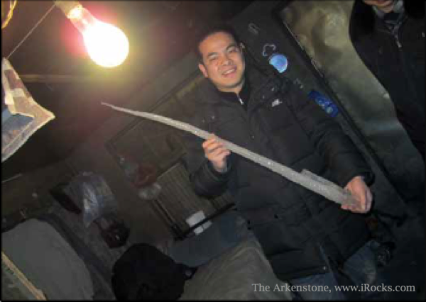The Arkenstone employee Chen Xiaojun plays with a meter-long icicle in Chifeng while hnting for fine mineral specimens.